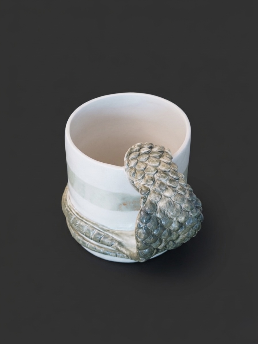 Serpent Mug (detail), 2025, Wheel-thrown porcelain with hand-modelled serpent, celadon and white glaze