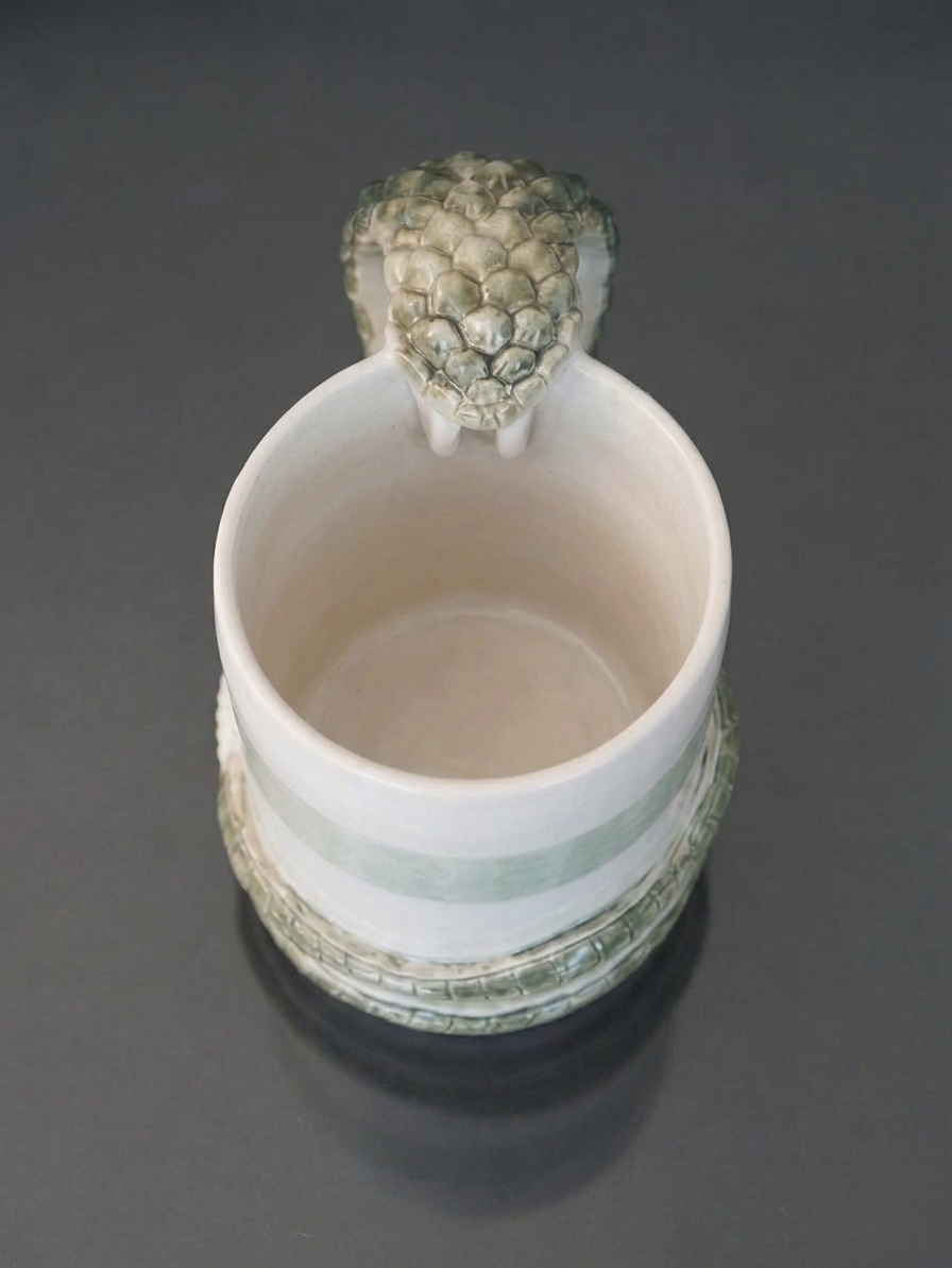 Serpent Mug (from above), 2025, Wheel-thrown porcelain with hand-modelled serpent, celadon and white glaze